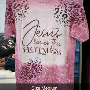 A short sleeve animal printed medium light weight pink and white shirt.